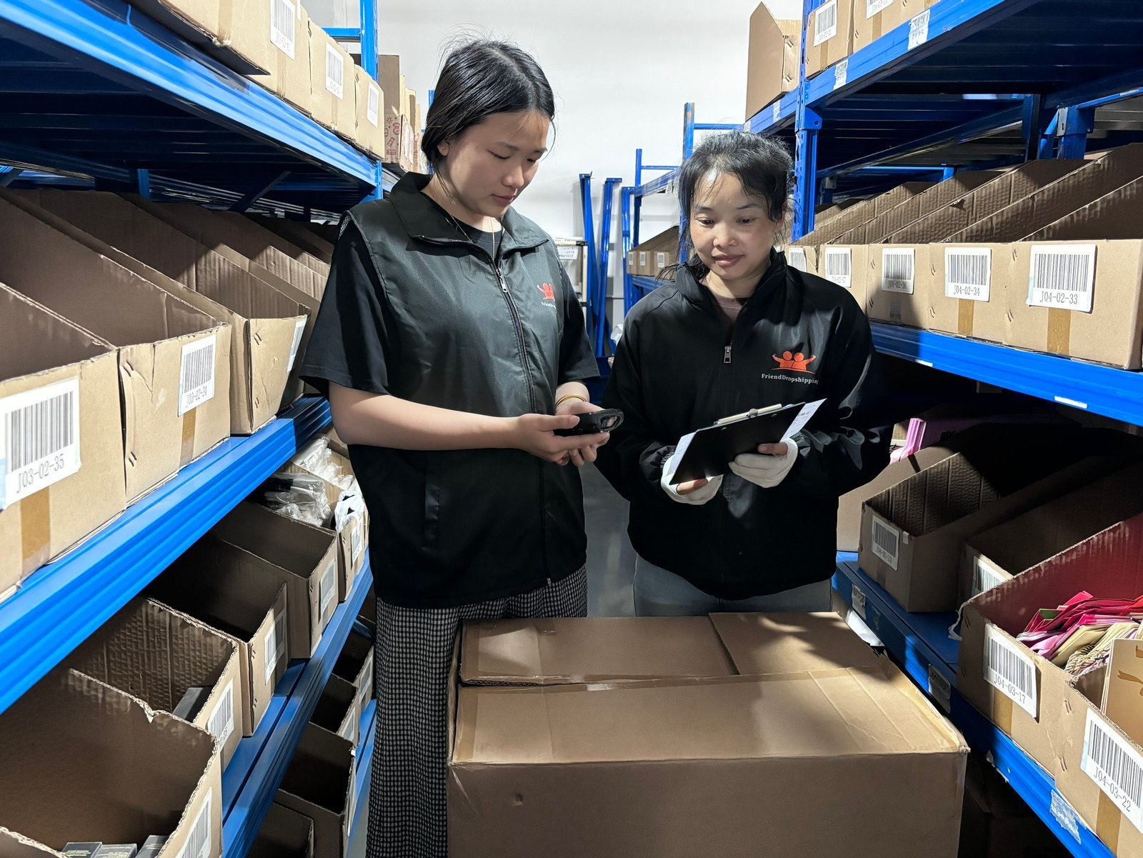 FriendDropshipping warehouse team reviewing Shopify fulfillment inventory and order instructions